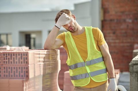 pracownik na budowie ociera pot z czoła 